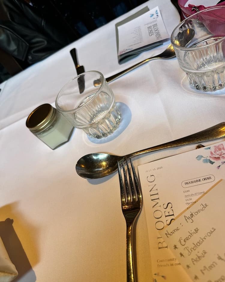 A place setting and the Blooming Sips menu at a community event